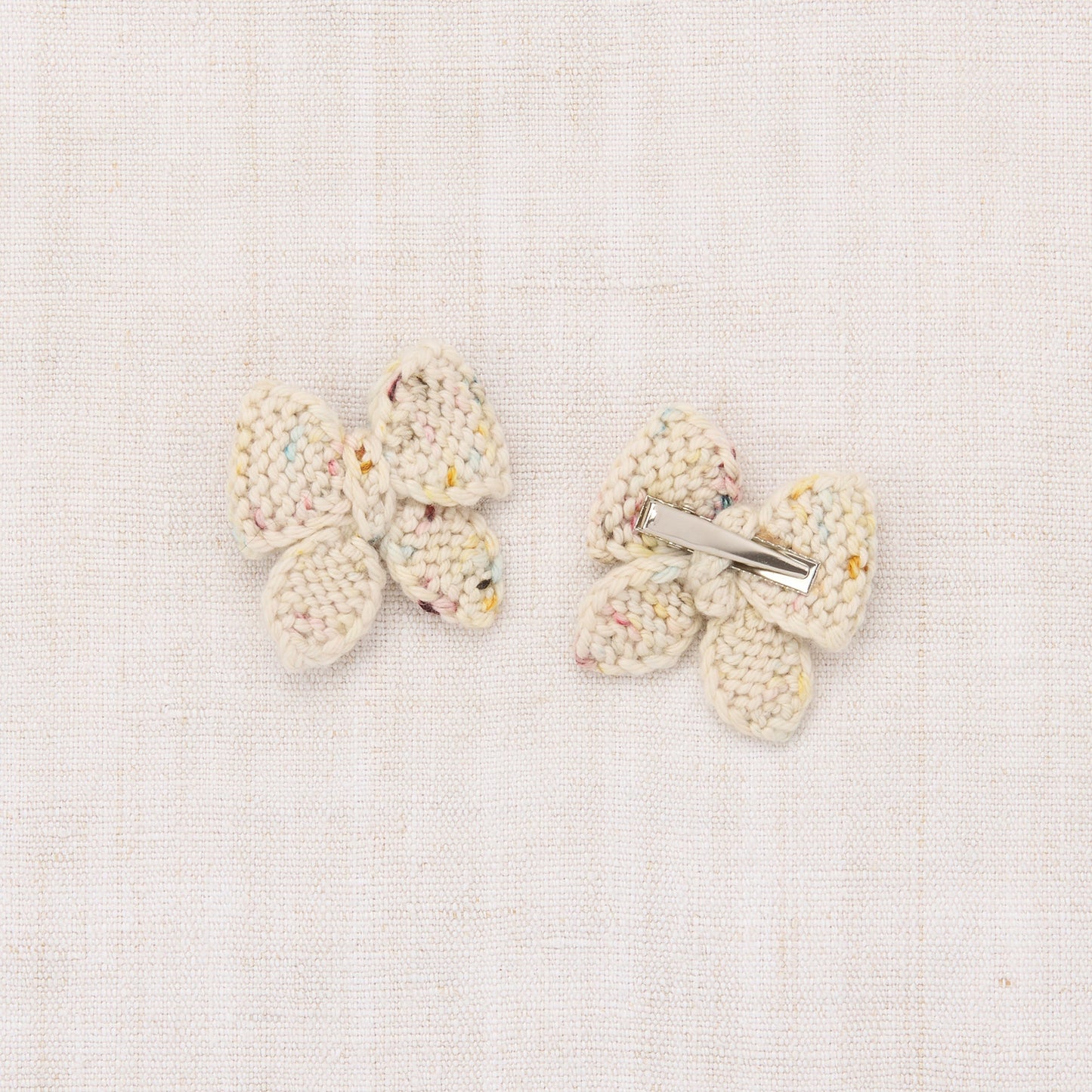 Pair of butterfly-shaped earrings on a light background