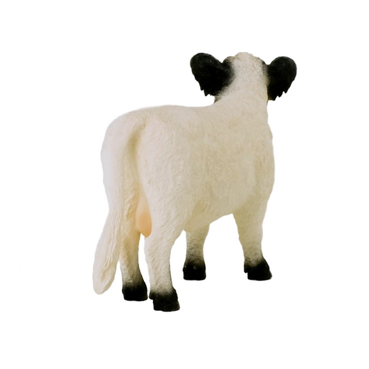 Sheep figurine with black face and ears on a white background