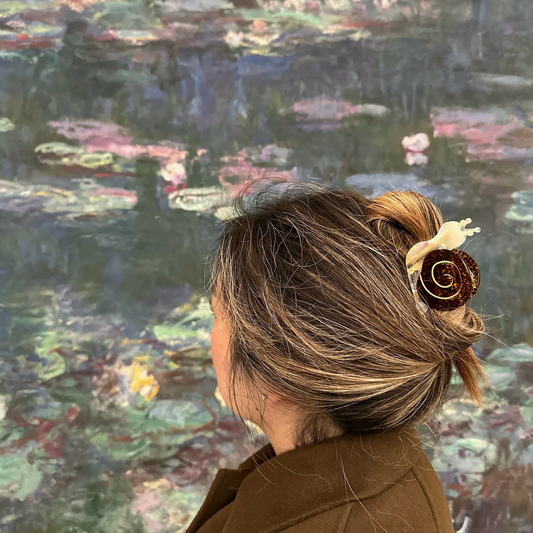 Person looking at a painting of water lilies