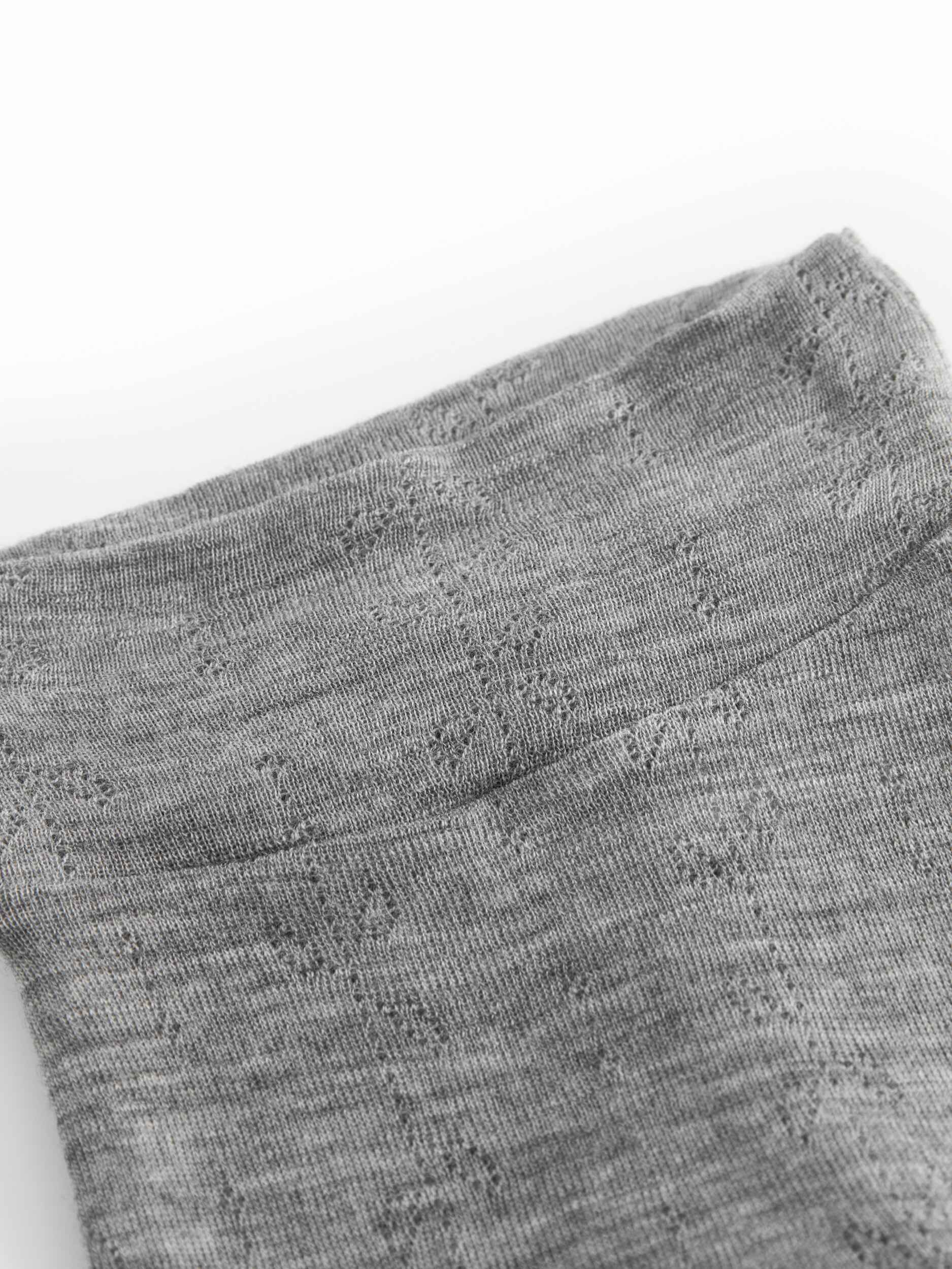 Close-up of gray socks with a textured pattern on a white background