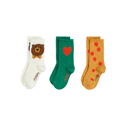 Three pairs of socks with different designs on a white background