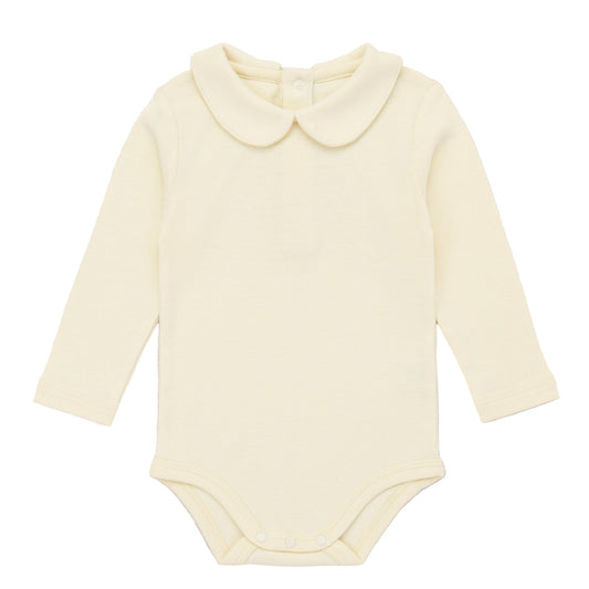 Yellow baby bodysuit with a collar on a light pink background