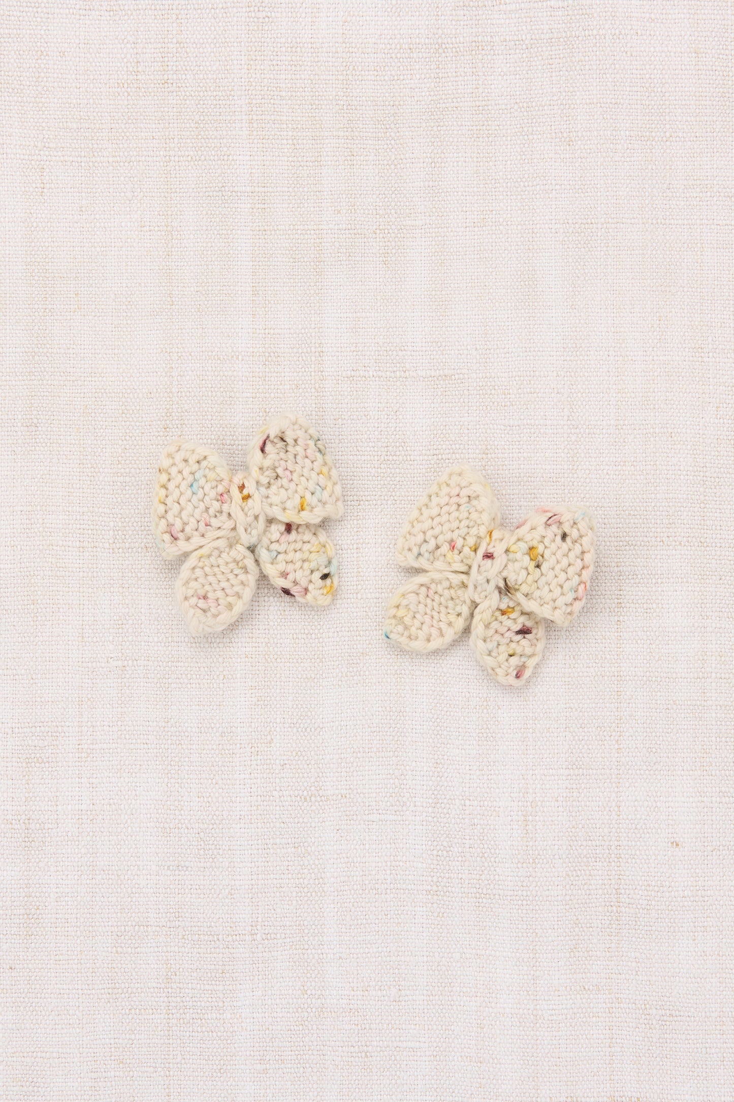 Pair of butterfly-shaped earrings on a light background