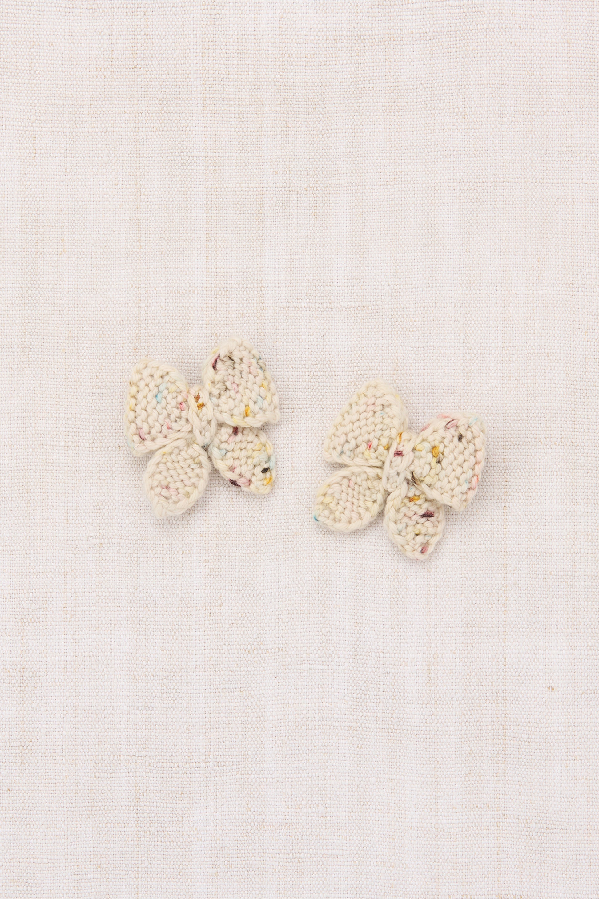 Pair of butterfly-shaped earrings on a light background