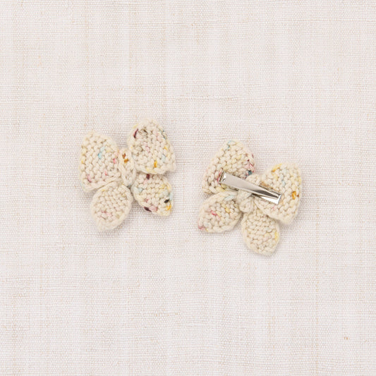 Pair of butterfly-shaped earrings on a light background