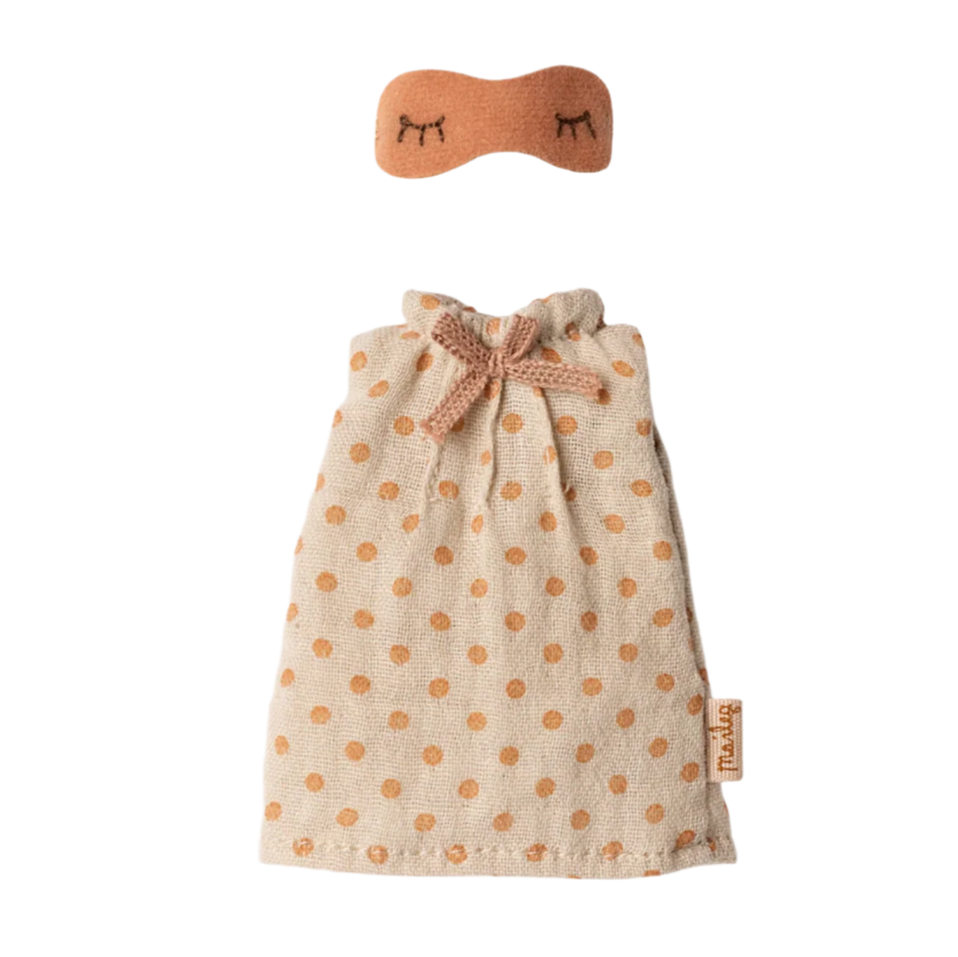Small dress with polka dot pattern and matching headband on a beige background