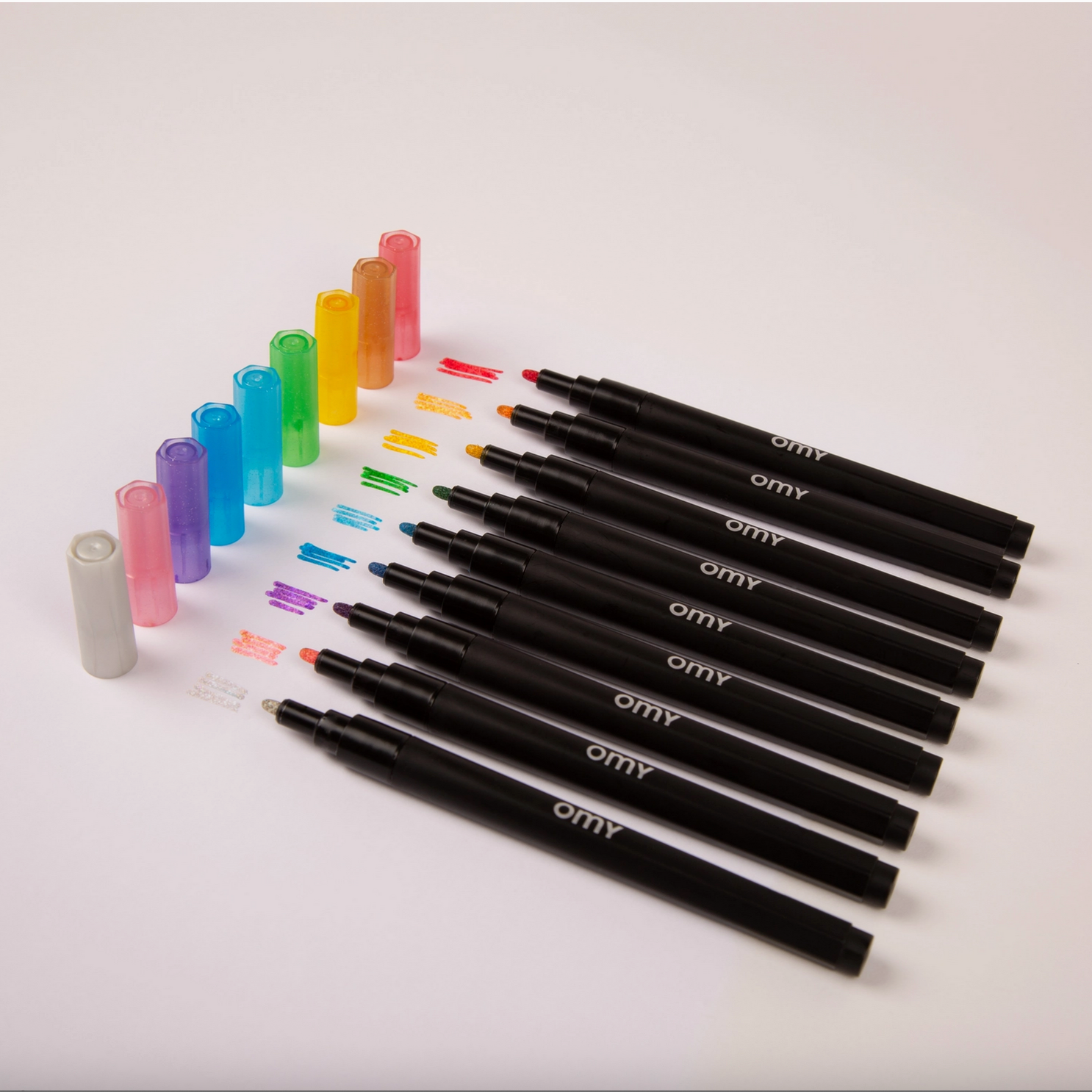 Set of black markers with colorful caps on a light gray background