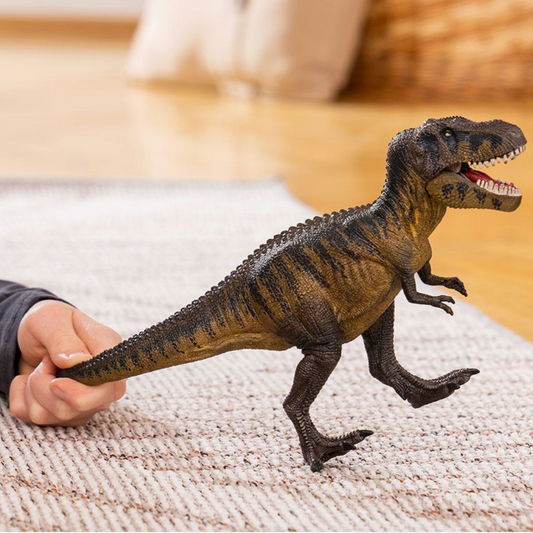 Toy dinosaur being held by a person on a textured surface