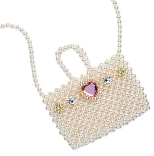Heart-shaped pearl handbag with decorative gems on a white background