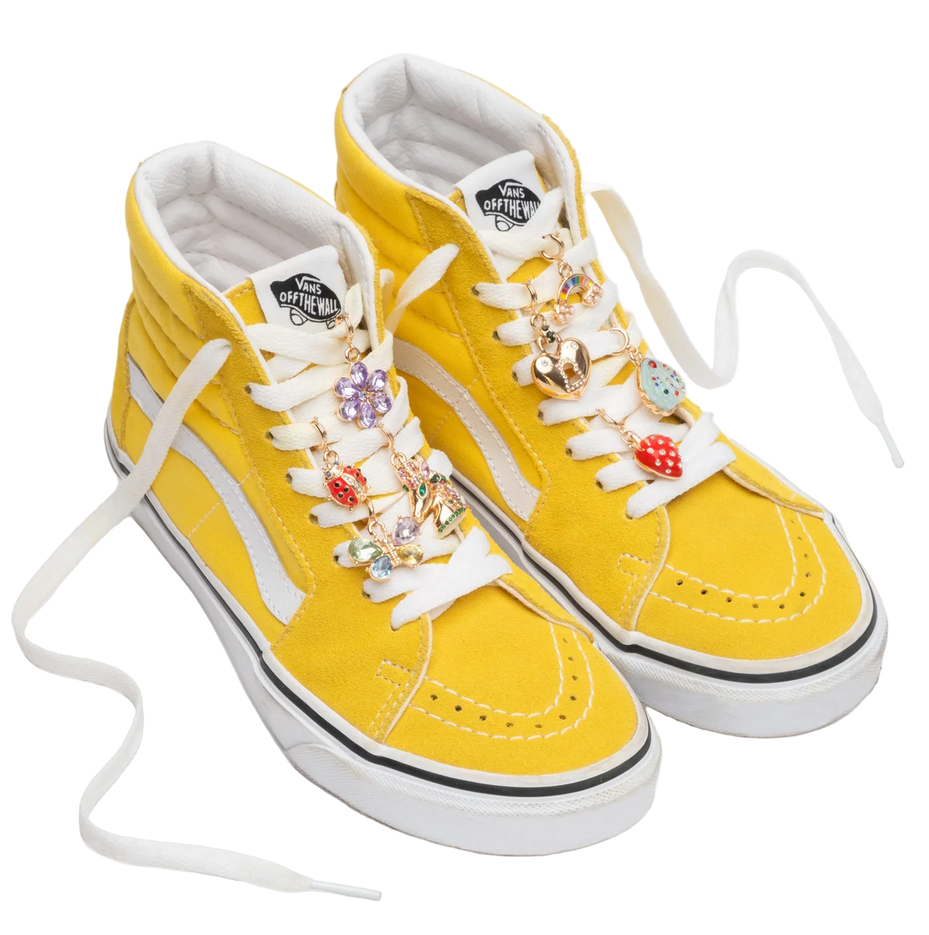Yellow high-top sneakers with decorative charms on a white background