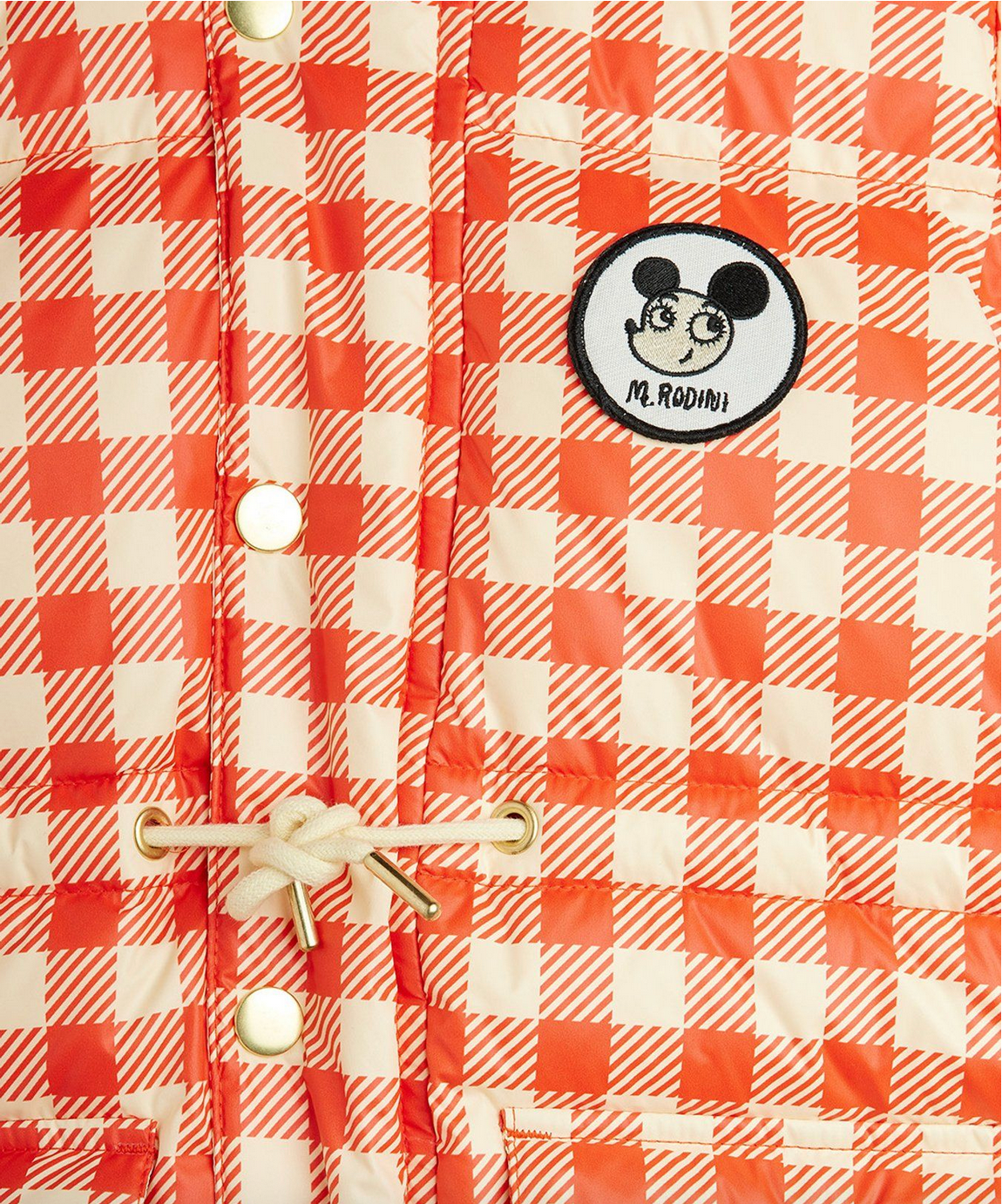Red and white checkered shirt with a patch on a plain background