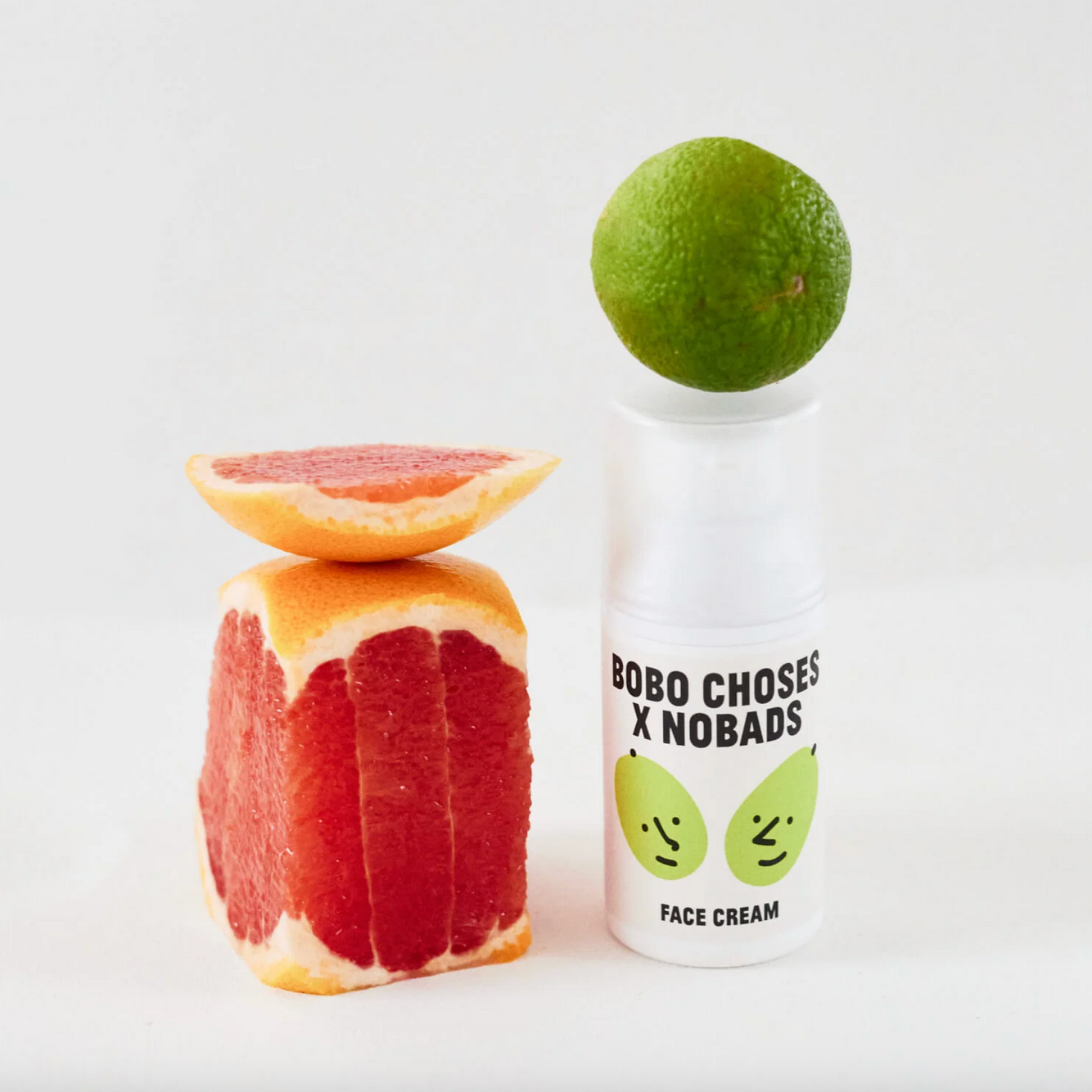 Bobo Choses x Nobads face cream bottle with citrus fruits on a white background