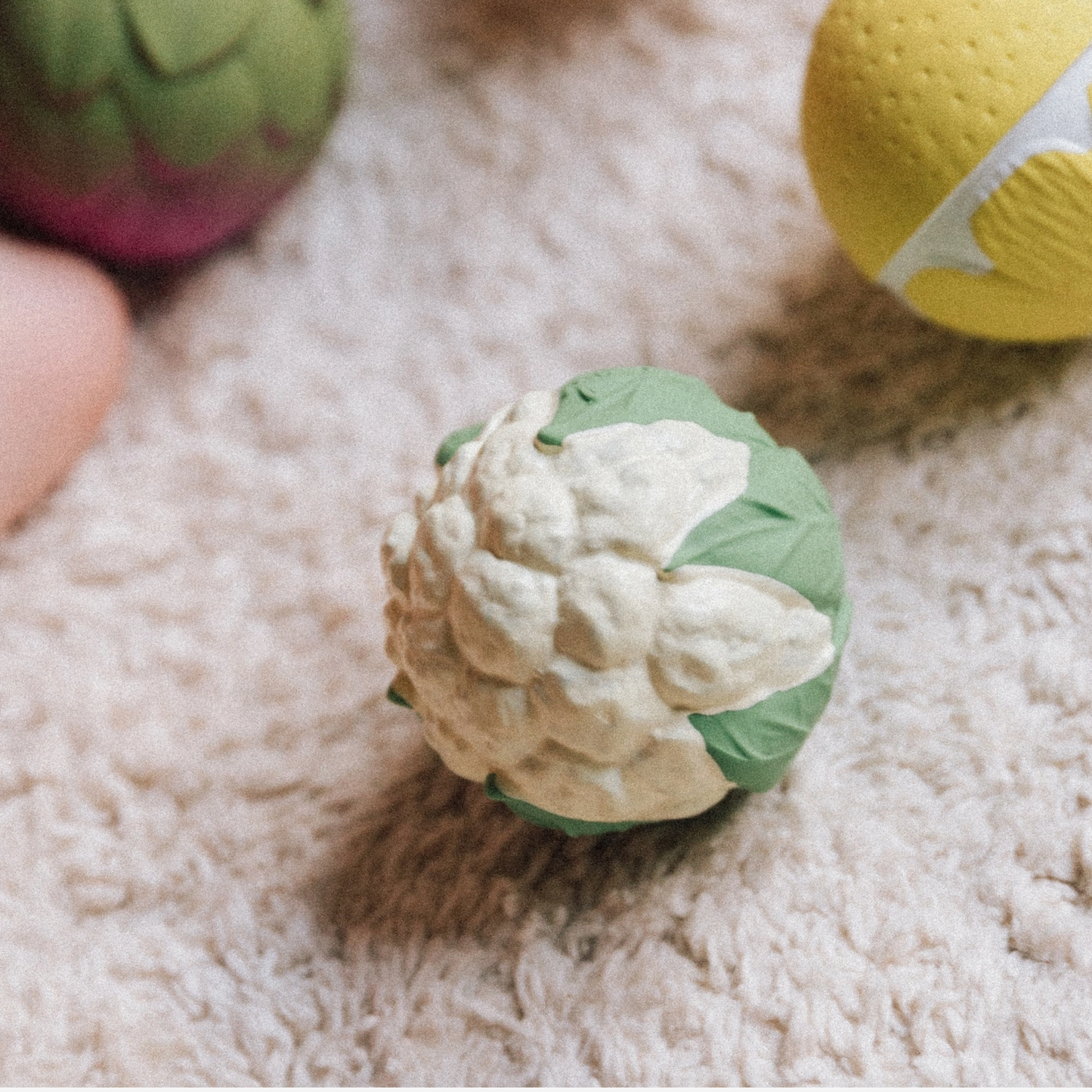 Green and white textured ball on a soft surface