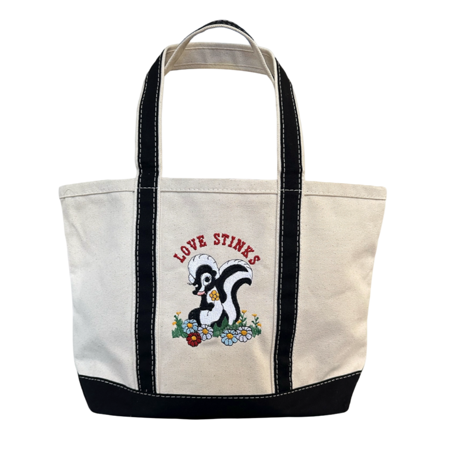 Tote bag with a skunk design and 'Love Stinks' text on a white background