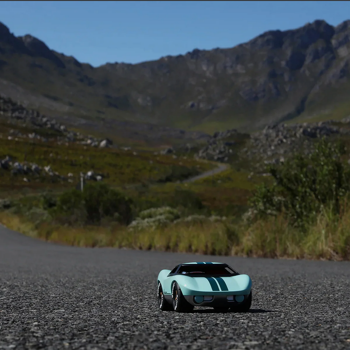 Vintage car on a mountain road with a scenic background
