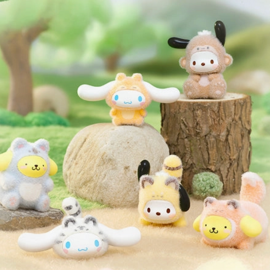 Set of small animal plush toys in a natural setting with trees and rocks.