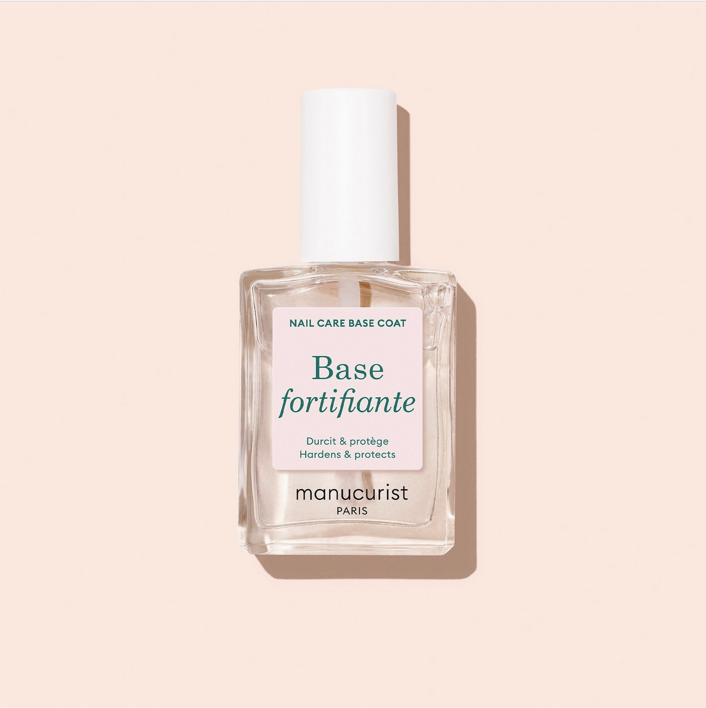 Manucurist nail care base coat bottle on a beige background