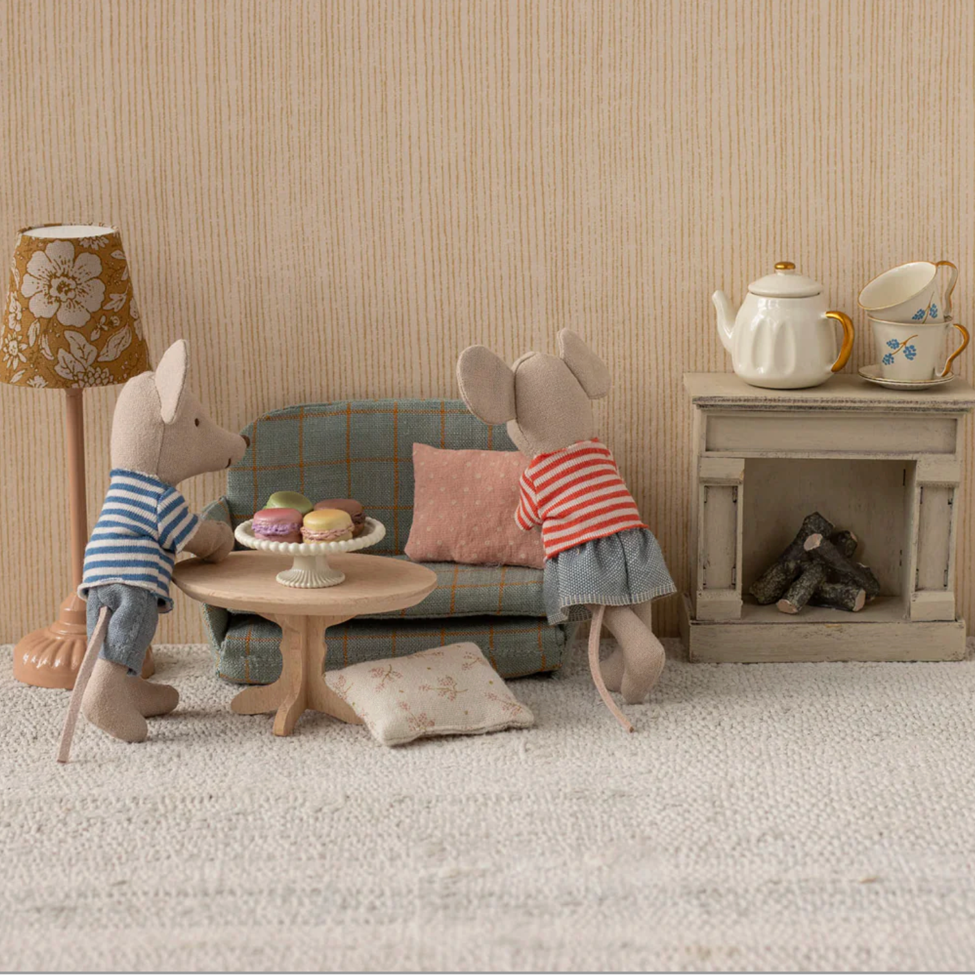 Two toy mice in a living room setting with furniture and decor.