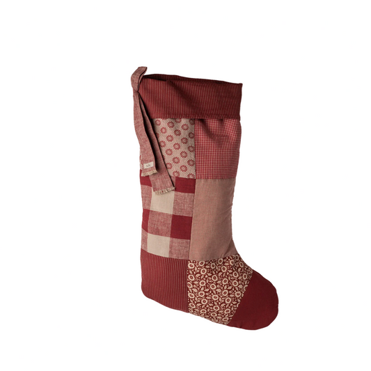 Patchwork-style red and brown stocking on a white background