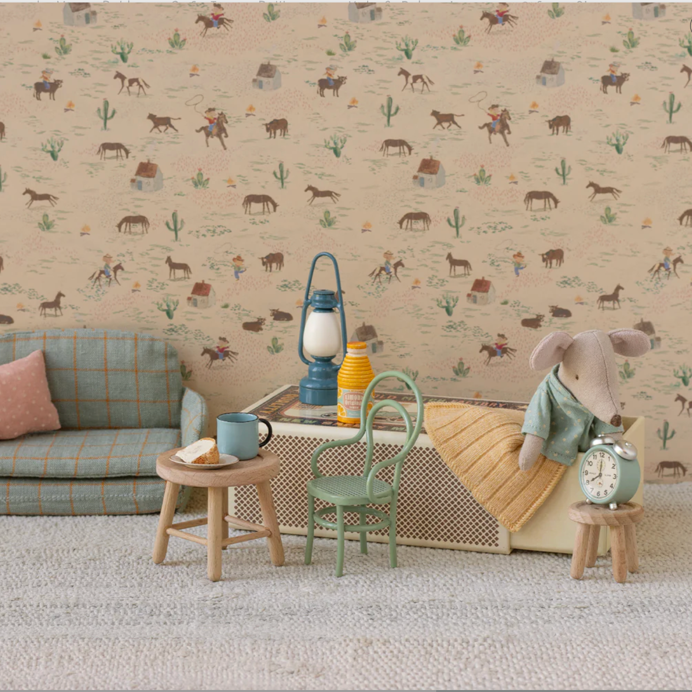 Children's room with patterned wallpaper, sofa, and toys.