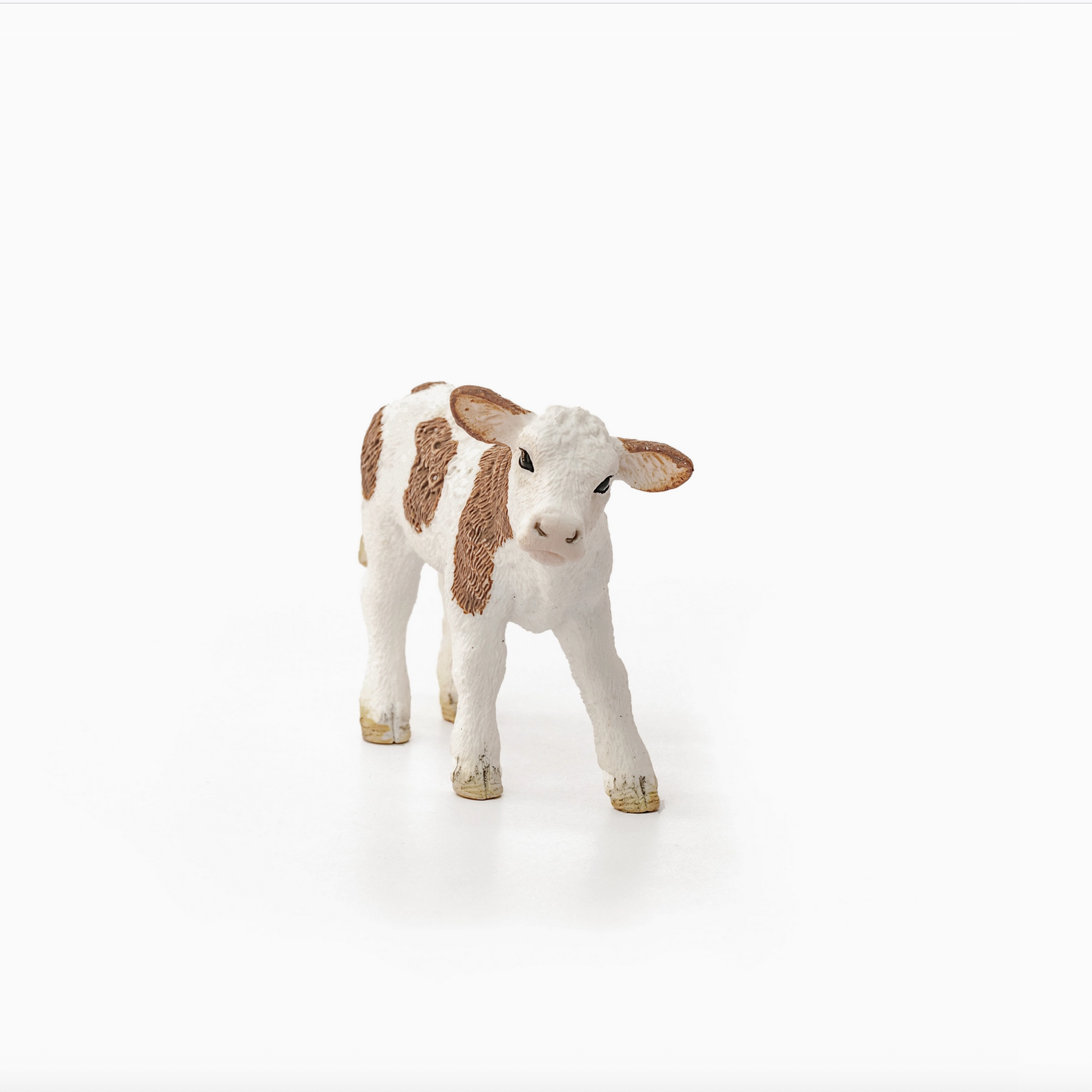 Stuffed animal cow toy on a white background