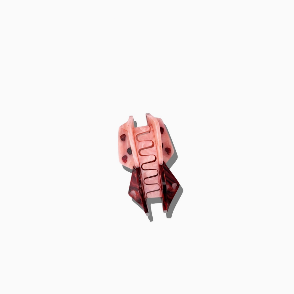 Pink and red mechanical component on a white background