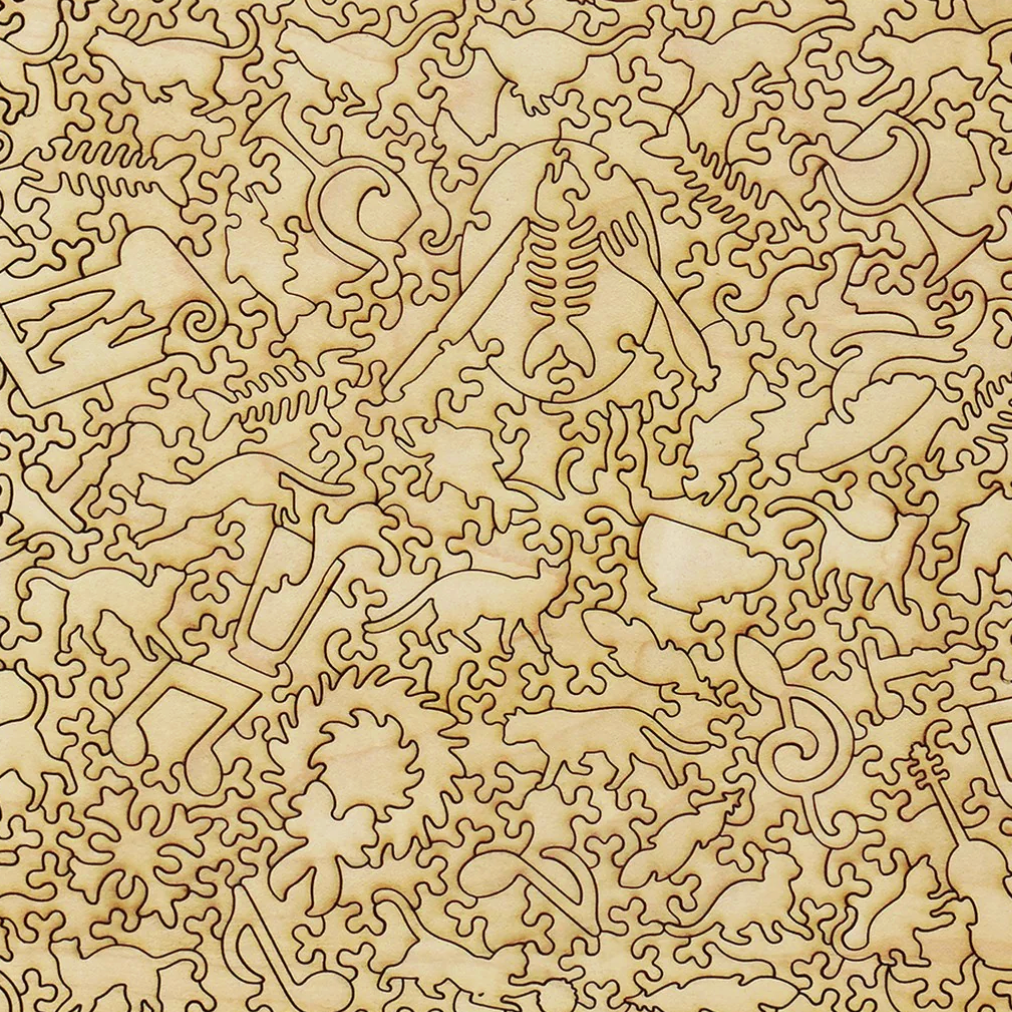 Pattern of laser-cut wooden letters and shapes on a beige background