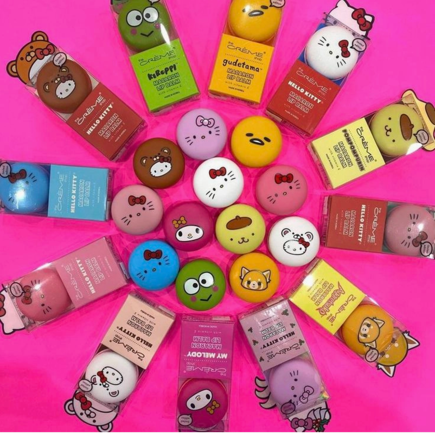 Collection of cartoon-themed makeup products on a pink background
