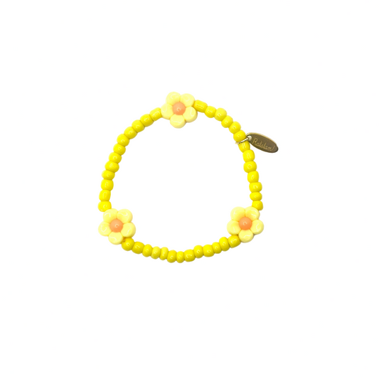 Yellow beaded bracelet with flower-shaped beads on a white background