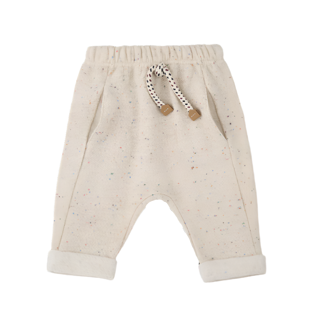 Beige baby pants with a rattle on a white background